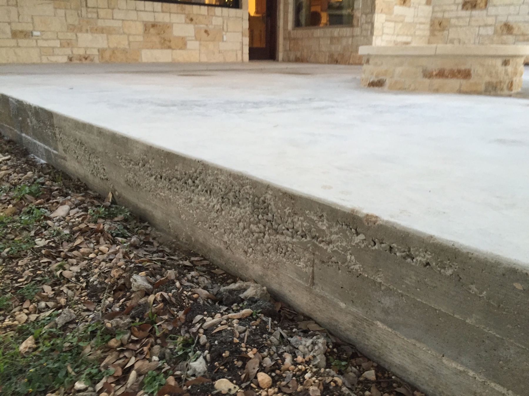 Close view of the existing patio slab edge before PetraBroom resurfacing
