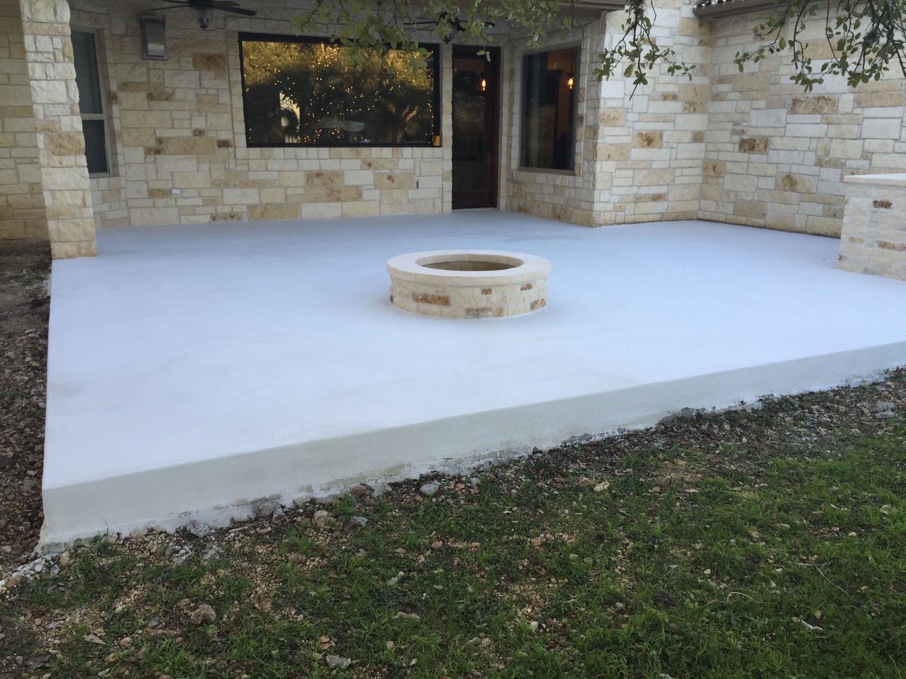 Light gray PetraBroom patio around the fire pit after the second coat